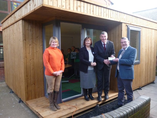 Mr Howard Davies Chairman and Trustee and Linda Scott OBE Trustee present a 
			cheque to Mr John Brine, Headteacher